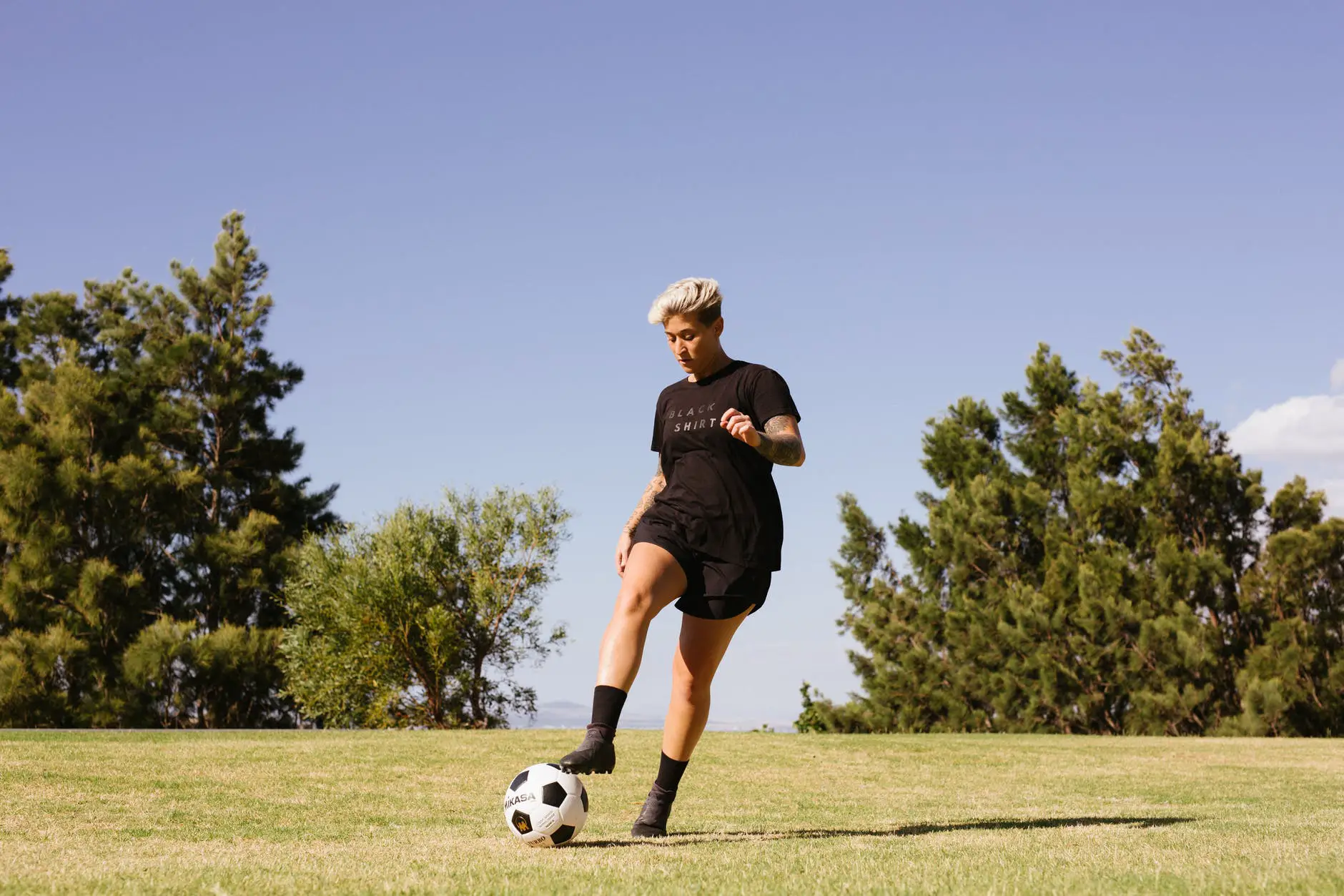 photo of person playing soccer on the field