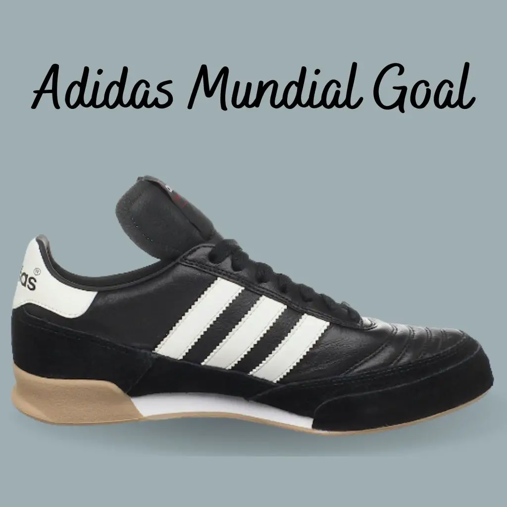 A white and black adidas mundial goal indoor soccer shoes for wide feet